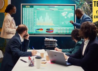 Startup team analyzing worldwide sales, shares and client feedback, using interactive boar to examine revenue and funds.