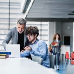 MBA student and professor checking a recommendations