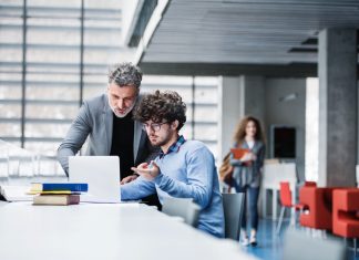 MBA student and professor checking a recommendations