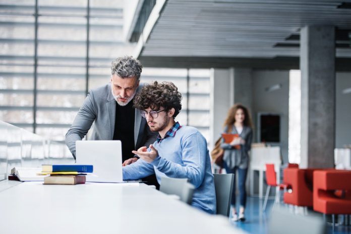 MBA student and professor checking a recommendations
