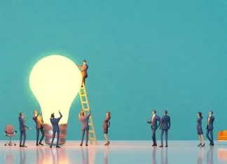 PDSA: The Secret Engine of Innovation Success Team of experiences professional people are working around big light bulb for PDSA project