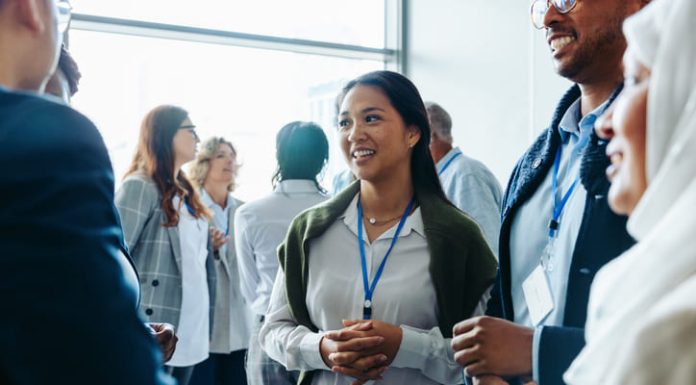 How to Network Like a Pro During Your MBA Program Corporate event with diverse attendees enjoying refreshments and networking