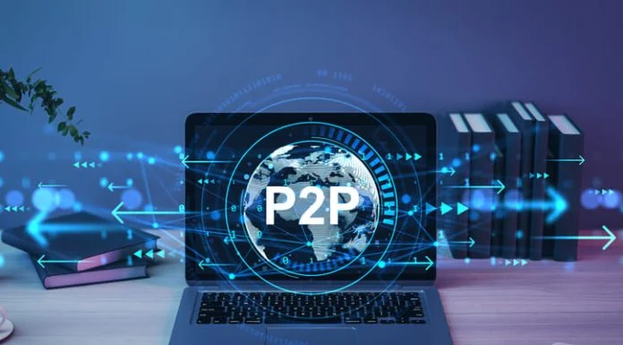 Laptop showing holographic globe with P2P text, digital light effects, on wooden desk in office