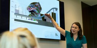 Female Engineer Holding Presentation for cloud environments