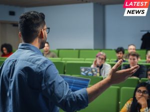 Male Teacher Giving a Lecture to a Diverse Multiethnic Group of Female and Male Students in Modern College Room