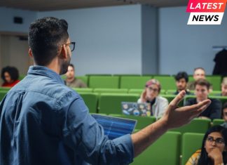 Male Teacher Giving a Lecture to a Diverse Multiethnic Group of Female and Male Students in Modern College Room