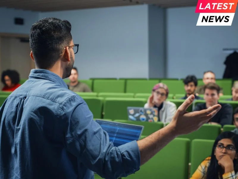 Male Teacher Giving a Lecture to a Diverse Multiethnic Group of Female and Male Students in Modern College Room