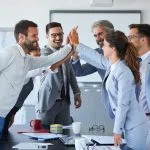 Successful businesspeople expressing motivation towards work.