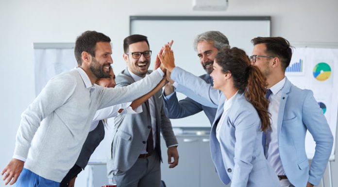 Successful businesspeople expressing motivation towards work.