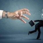 Business man with doodle icons running from a big hand concept on background