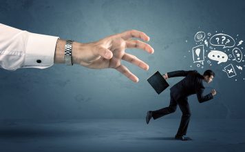 Business man with doodle icons running from a big hand concept on background