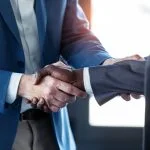 Close-up view of business partner handshaking for hybrid support teams
