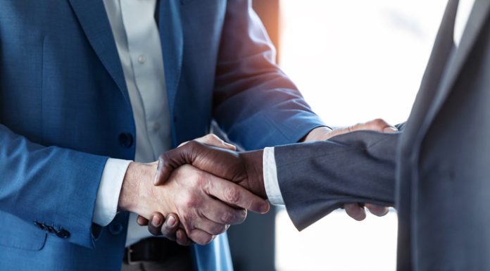 Why Hybrid Support Teams Outperform Fully In-House Departments Close-up view of business partner handshaking for hybrid support teams