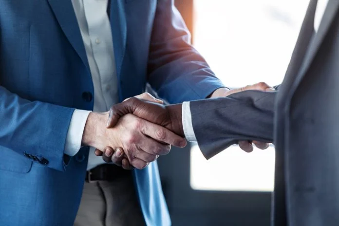 Close-up view of business partner handshaking for hybrid support teams