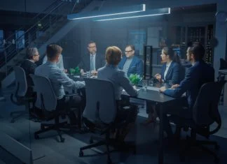 How Private Investigators Fit into a Corporate Risk Management Budget In the Modern Corporate Meeting Room: Diverse Group of Businesspeople, Private investigators, Lawyers, Executives and Directors Talking