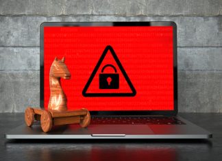 Trojan Proxies: What they are and What are their Benefits? Encrypted notebook with a wooden trojan horse on the table