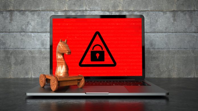 Encrypted notebook with a wooden trojan horse on the table