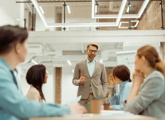 Man standing in office and storytelling and explaining new ideas to colleague