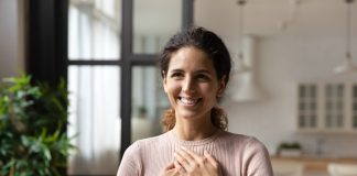Hispanic woman put folded palms on chest feels gratitude