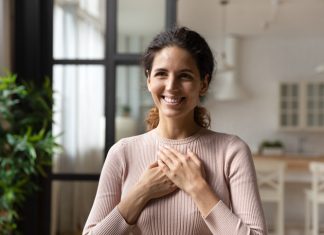 Hispanic woman put folded palms on chest feels gratitude