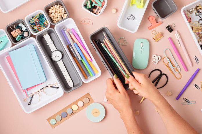 iStock-1421660834 (1) Desktop organization. Cleaning up messy stationery in plastic organizers for office and home desk