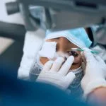 Close up of female patient having laser surgery at eye clinic.