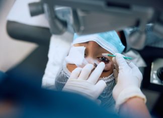 Close up of female patient having laser surgery at eye clinic.