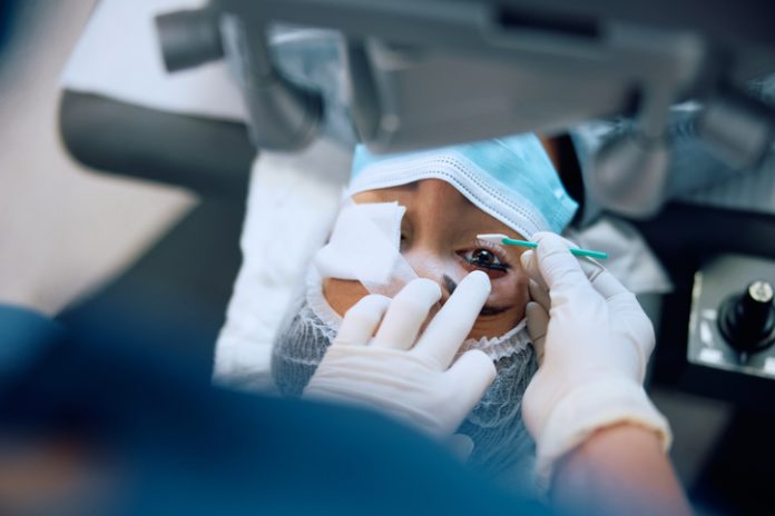 Close up of female patient having laser surgery at eye clinic.