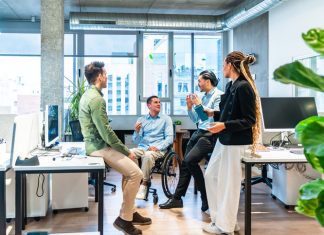Reputation Equity: The Missing Piece in the DEI Conversation Business team discussing ideas, reputation equity in modern office with disabled colleague