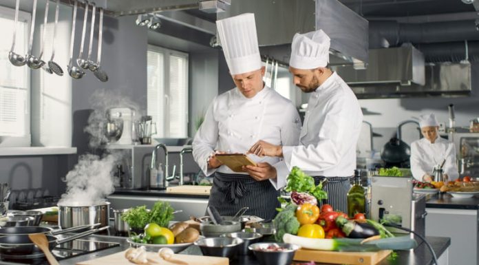 Chefs discussing e new recipe in the kitchen