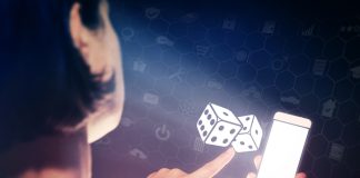 Image of a girl with a smartphone in hands. She presses on the dice icon. Concept of entertainment and iGaming