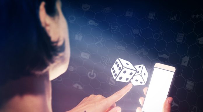 How iGaming is Pushing Digital Payments to Get Smarter, Faster, and More Inclusive Image of a girl with a smartphone in hands. She presses on the dice icon. Concept of entertainment and iGaming