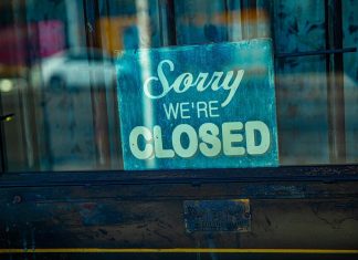 company close signage on a glass door