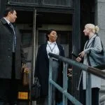 corporate coworkers chatting near building after work about retreat