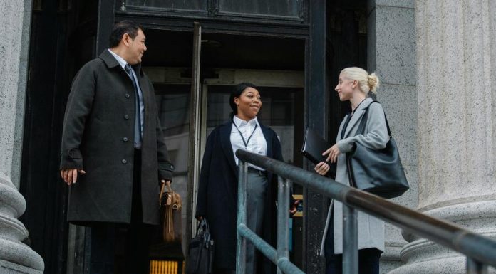 corporate coworkers chatting near building after work about retreat