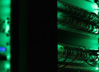 How Can You Secure Your Confidential Documents with a Virtual Data Room? a rack of electronic equipment in a dark room
