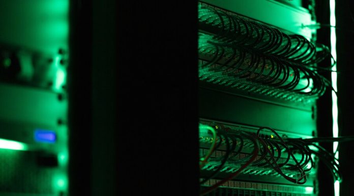 How Can You Secure Your Confidential Documents with a Virtual Data Room? a rack of electronic equipment in a dark room