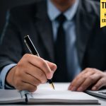 How to Write the Perfect Elevator Pitch that Wins Attention Fast Businessman writing an elevator pitch