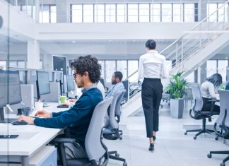 Beautiful Female Manager is Walking Pass Her Business Colleagues while working, experiments to optimize AI and algorithmic attachments.