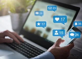 The Smart Way to Grow on Social Media (Without Posting Every Day) Like, share and post on social media. Hands holding smartphone with social media network icons.