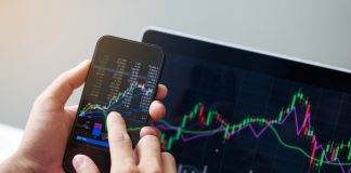 StateFunds.com Strengthens Portfolios Through Risk Control Tools Businessman hand holding phone and analysis finance market graph stock market trading, stock chart and investment