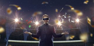 Handsome businessman in VR glasses standing on 3D sport arena with many chips, tokens. Online game.