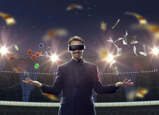 Handsome businessman in VR glasses standing on 3D sport arena with many chips, tokens. Online game.