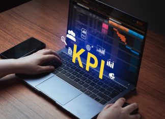 Beyond Traditional Business KPIs: How Modern Financial Metrics Drive Digital Transformation Woman use laptop with KPI holographic interface on screen.