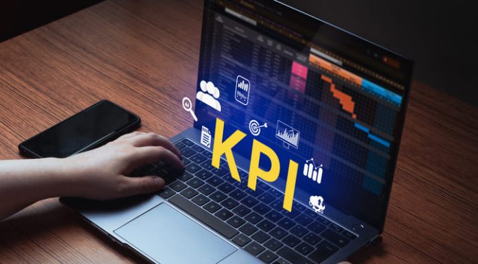 Woman use laptop with KPI holographic interface on screen.