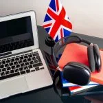 Mastering Everyday English with the Help of AI English language learning concept with books and flag of Great Britain