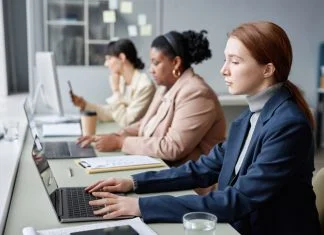 Why Don’t More Women Work in Tech and What Can We Do About it? Women in Tech Working on Computers in Office