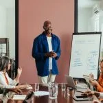 Business leaders having training workshop in modern office boardroom.