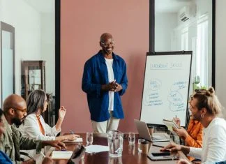 Business leaders having training workshop in modern office boardroom.