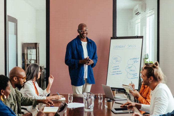 Business leaders having training workshop in modern office boardroom.